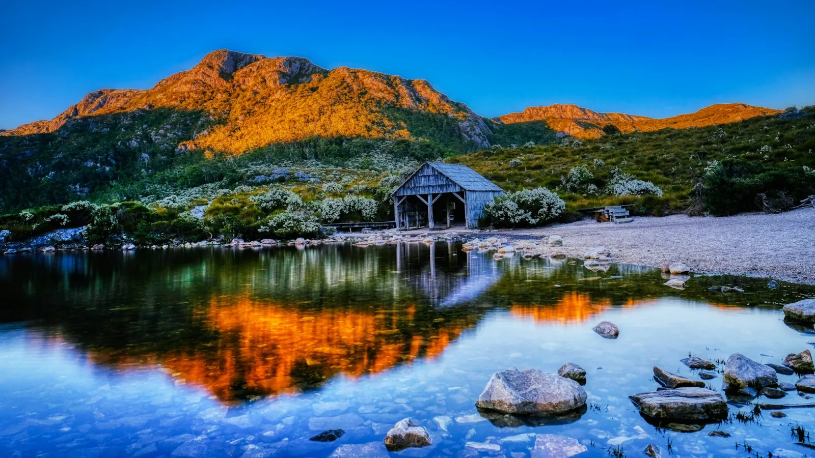 The old timber boatshed on the edge of Dove Lake, with Cradle Mountain behind